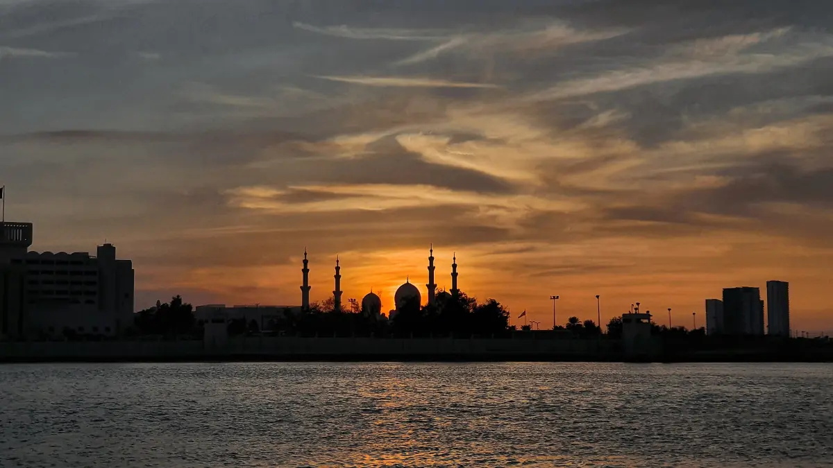 Domes and minarets of the mosque as a silhouette at dusk