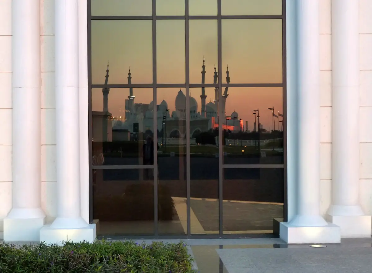 The mosque reflected in a hotel window at sunset